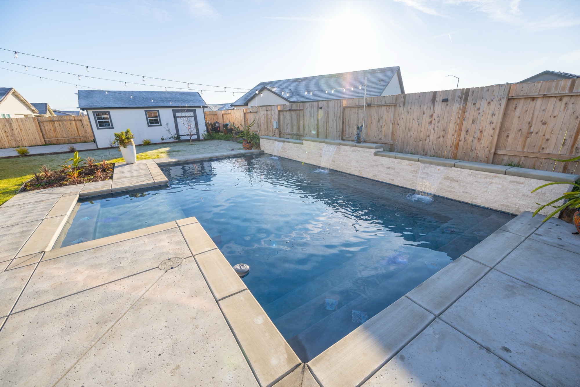 Custom gunite pool with dark plaster at golden hour